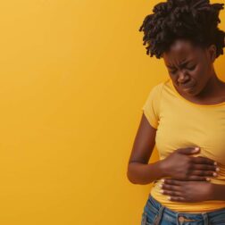 Black Woman touching her tummy suffering from menstrual pain