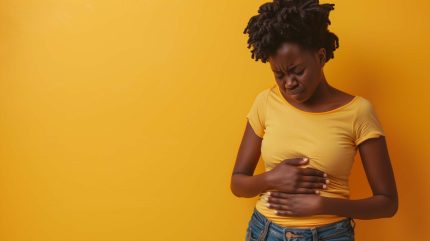 Black Woman touching her tummy suffering from menstrual pain
