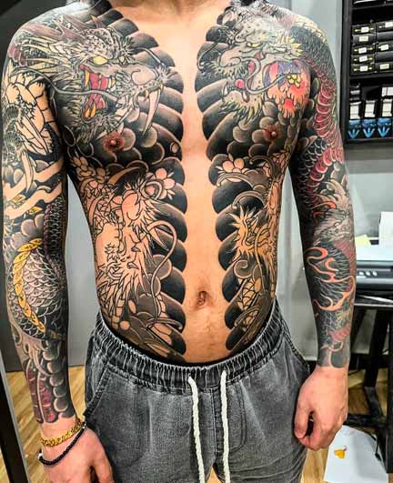 A man with japanese dragon tattoo design on the body